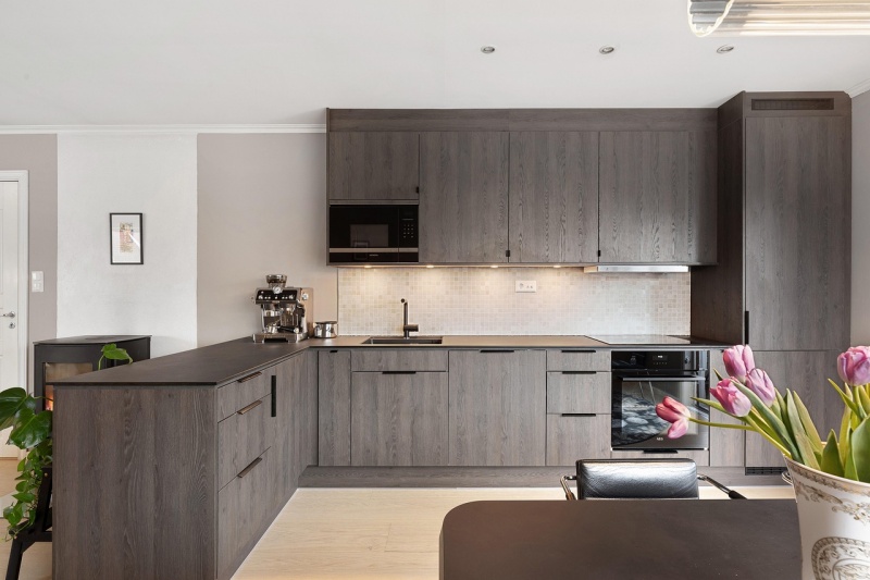 Dark wood cabinets with black countertops Dark wood cabinets with black countertops