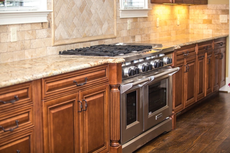 Rustic tan travertine with dark wood cabinets
